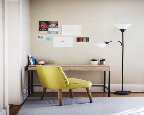 desk lamp casting warm light on a wooden table